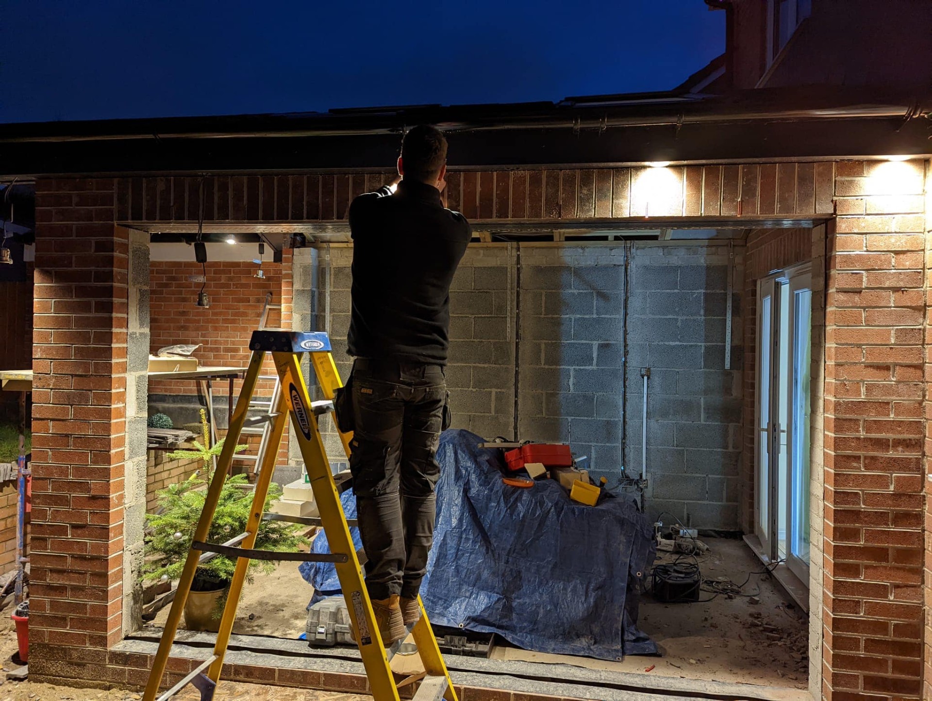 Bryan Electrical fitting exterior soffit lighting at dusk